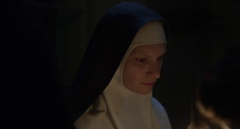 Movie still from “The Innocents” (2016), directed by Anne Fontaine – A woman wearing a nun's habit and a white veil; Close Up shot, Low angle