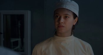 Movie still from “The Innocents” (2016), directed by Anne Fontaine – A woman wearing a white hat and a white shirt; Close Up shot, Low angle
