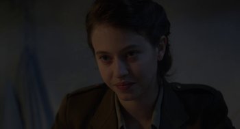 Movie still from “The Innocents” (2016), directed by Anne Fontaine – A young woman in a military uniform looking at the camera; Close Up shot, Over the shoulder angle