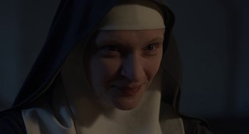 Movie still from “The Innocents” (2016), directed by Anne Fontaine – A woman wearing a nun's habit and a white head scarf; Close Up shot, Low angle