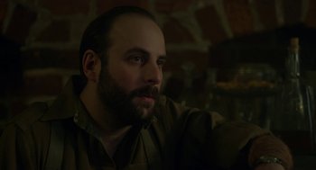 Movie still from “The Innocents” (2016), directed by Anne Fontaine – A man with a goatee and a beard looking to his left; Close Up shot, Low angle