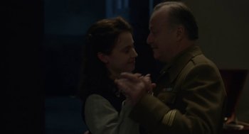 Movie still from “The Innocents” (2016), directed by Anne Fontaine – A man and a woman are dancing together in the dark; Medium shot, Low angle