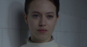 Movie still from “The Innocents” (2016), directed by Anne Fontaine – A person wearing a white shirt; Close Up shot, Low angle