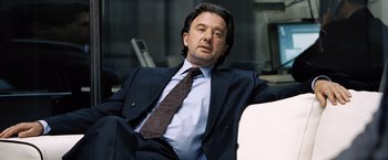 Movie still from “The International” (2009), directed by Tom Tykwer – A person wearing a suit and tie; Close Up shot, Low angle