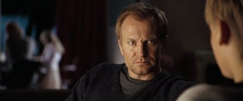 Movie still from “The International” (2009), directed by Tom Tykwer – A person wearing a sweater; Close Up shot, Low angle