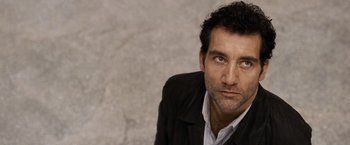 Movie still from “The International” (2009), directed by Tom Tykwer – A person wearing a jacket; Close Up shot, Low angle