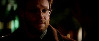 Movie still from “The Interview” (2014), directed by Evan Goldberg – A person wearing glasses; Close Up shot, Over the shoulder angle