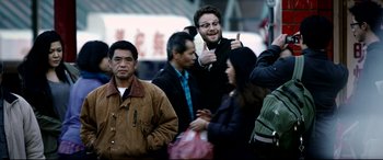 Movie still from “The Interview” (2014), directed by Evan Goldberg – A group of people standing around each other in the street; Medium shot, Over the shoulder angle