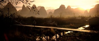 Movie still from “The Interview” (2014), directed by Evan Goldberg – A person standing on a bridge near a body of water; Extreme Wide shot, High angle