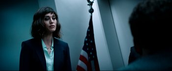 Movie still from “The Interview” (2014), directed by Evan Goldberg – A woman standing in front of an american flag; Medium shot, Low angle