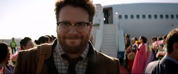 Movie still from “The Interview” (2014), directed by Evan Goldberg – A person wearing a suit and tie; Close Up shot, Over the shoulder angle
