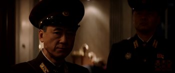 Movie still from “The Interview” (2014), directed by Evan Goldberg – A man in a military uniform is standing in a room; Close Up shot, Over the shoulder angle