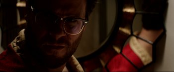 Movie still from “The Interview” (2014), directed by Evan Goldberg – A person wearing glasses in front of a mirror; Close Up shot, Low angle