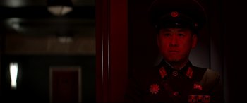 Movie still from “The Interview” (2014), directed by Evan Goldberg – A man in a uniform is posing for a picture; Close Up shot, Low angle