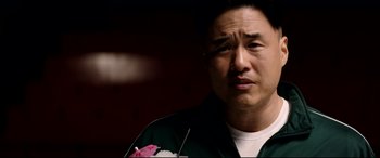 Movie still from “The Interview” (2014), directed by Evan Goldberg – A person wearing a green shirt; Close Up shot, Low angle