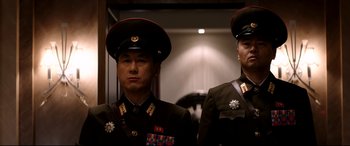 Movie still from “The Interview” (2014), directed by Evan Goldberg – A couple of men standing next to each other in uniform; Medium shot, Low angle