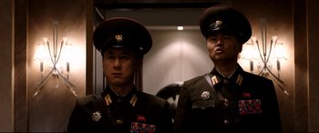 Movie still from “The Interview” (2014), directed by Evan Goldberg – A couple of men standing next to each other; Medium shot, Low angle