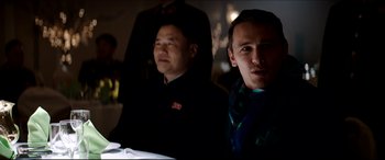 Movie still from “The Interview” (2014), directed by Evan Goldberg – Two men sitting at a table in front of a mirror; Medium shot, Over the shoulder angle