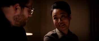 Movie still from “The Interview” (2014), directed by Evan Goldberg – A woman in a military uniform is looking at the camera; Close Up shot, Over the shoulder angle