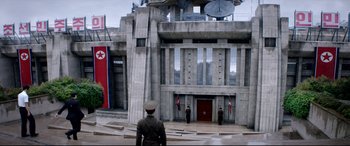 Movie still from “The Interview” (2014), directed by Evan Goldberg – A group of men standing in front of a large building; Extreme Wide shot, Low angle