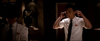 Movie still from “The Interview” (2014), directed by Evan Goldberg – A man in a white shirt and black neck tie is talking on the phone; Close Up shot, Low angle