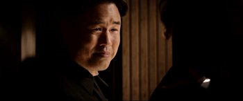 Movie still from “The Interview” (2014), directed by Evan Goldberg – A person wearing a black shirt; Close Up shot, Over the shoulder angle