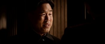 Movie still from “The Interview” (2014), directed by Evan Goldberg – A person wearing a black shirt; Close Up shot, Over the shoulder angle