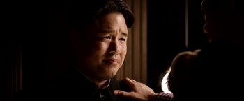 Movie still from “The Interview” (2014), directed by Evan Goldberg – An asian man is getting his hair combed; Close Up shot, Over the shoulder angle