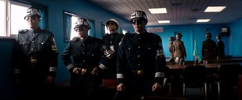 Movie still from “The Interview” (2014), directed by Evan Goldberg – A group of men in uniform standing next to each other; Medium shot, Low angle