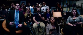 Movie still from “The Interview” (2014), directed by Evan Goldberg – A group of people sitting in a room with wine glasses; Wide shot, High angle