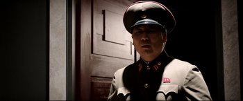 Movie still from “The Interview” (2014), directed by Evan Goldberg – A man in a military uniform standing in front of a door; Close Up shot, Low angle