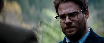 Movie still from “The Interview” (2014), directed by Evan Goldberg – A person wearing glasses with blood on his face; Close Up shot, Over the shoulder angle