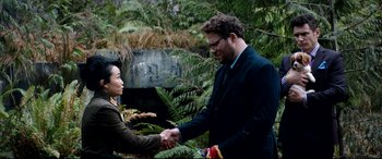Movie still from “The Interview” (2014), directed by Evan Goldberg – A man and a woman shaking hands in a wooded area; Medium shot, Over the shoulder angle