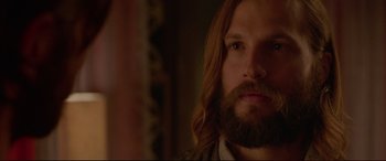 Movie still from “The Invitation” (2015), directed by Karyn Kusama – A person with long hair and a beard; Close Up shot, Over the shoulder angle