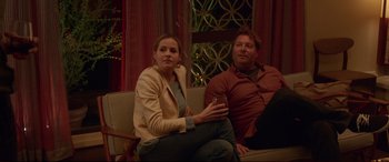 Movie still from “The Invitation” (2015), directed by Karyn Kusama – A woman and a man are sitting on a couch; Medium shot, Over the shoulder angle