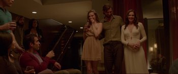 Movie still from “The Invitation” (2015), directed by Karyn Kusama – A man and a woman standing next to each other in a room; Medium shot, Over the shoulder angle