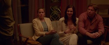 Movie still from “The Invitation” (2015), directed by Karyn Kusama – Two women are sitting on a couch and one of them is holding a glass of wine; Medium shot, High angle