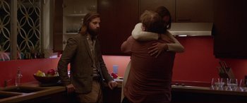 Movie still from “The Invitation” (2015), directed by Karyn Kusama – A group of people hugging in a room; Medium shot, Over the shoulder angle