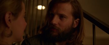 Movie still from “The Invitation” (2015), directed by Karyn Kusama – A person with long hair and a beard; Close Up shot, Over the shoulder angle