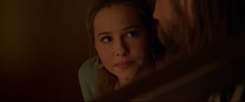 Movie still from “The Invitation” (2015), directed by Karyn Kusama – A person looking at the camera; Close Up shot, Over the shoulder angle