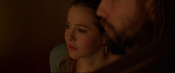 Movie still from “The Invitation” (2015), directed by Karyn Kusama – A person looking at a camera; Close Up shot, Over the shoulder angle