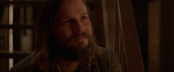 Movie still from “The Invitation” (2015), directed by Karyn Kusama – A person with long hair and a beard; Close Up shot, Over the shoulder angle