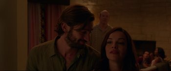 Movie still from “The Invitation” (2015), directed by Karyn Kusama – A man and a woman standing next to each other in a room; Close Up shot, Over the shoulder angle