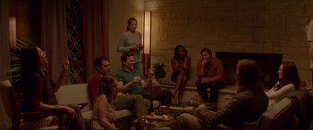 Movie still from “The Invitation” (2015), directed by Karyn Kusama – A group of people sitting around in a living room; Wide shot, High angle
