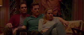 Movie still from “The Invitation” (2015), directed by Karyn Kusama – A man and a woman sitting next to each other on a couch; Medium shot, Low angle