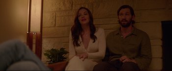 Movie still from “The Invitation” (2015), directed by Karyn Kusama – A woman sitting next to a man on a bench; Medium shot, Low angle