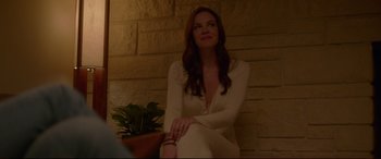 Movie still from “The Invitation” (2015), directed by Karyn Kusama – A woman in a white dress sitting on the ground; Medium shot, Over the shoulder angle