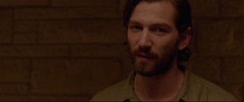 Movie still from “The Invitation” (2015), directed by Karyn Kusama – A person with a beard; Close Up shot, Over the shoulder angle