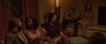Movie still from “The Invitation” (2015), directed by Karyn Kusama – A group of people sitting around a room; Medium shot, Over the shoulder angle