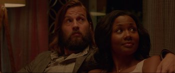 Movie still from “The Invitation” (2015), directed by Karyn Kusama – A man and a woman sitting next to each other; Close Up shot, Low angle